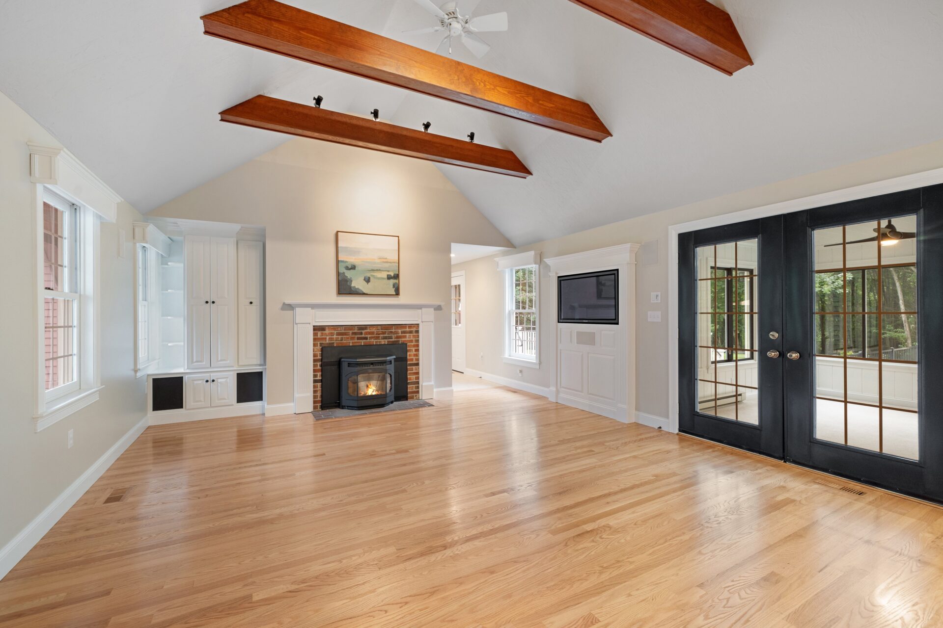 A modern living room after the hardwood floor refinishing process restored the natural beauty of the wood.